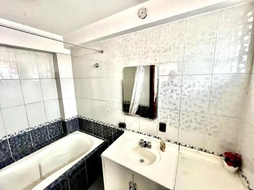 a bathroom with a tub and a sink and a bath tub at Cusco House Inn Hostel in Cusco