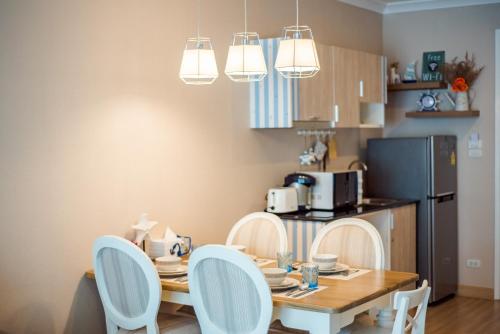 a kitchen with a table and chairs in a room at Hua Hin My Resort 3BR Family Condo Free Water Park Walk to Beach & Cicada Night Market หัวหิน ห้องแฟมมิลี่ 3 ห้องนอน ฟรีสวนน้ำ ใกล้ทะเลและตลาดซิเคด้า in Hua Hin