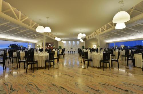 a banquet hall with tables and chairs and lights at Mec Paestum Hotel in Paestum