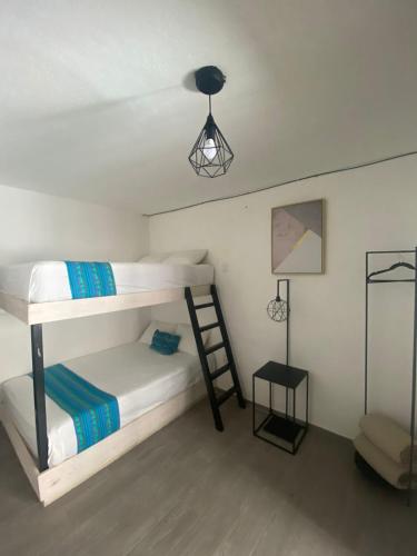 a bedroom with two bunk beds and a ladder at Casa Malva Sweet Stay in Guanajuato