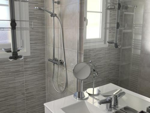 a bathroom with a shower and a sink with a mirror at Gîte Vars, 4 pièces, 6 personnes - FR-1-653-16 in Vars