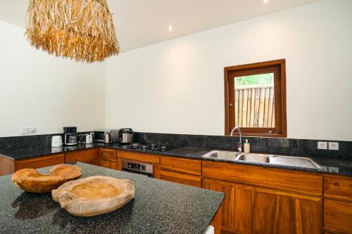 a kitchen with a counter top with a sink at Villa Ravenala, Sumptuous 5BR Luxury Villa 10min away from Lovina in the North of Bali in Lovina