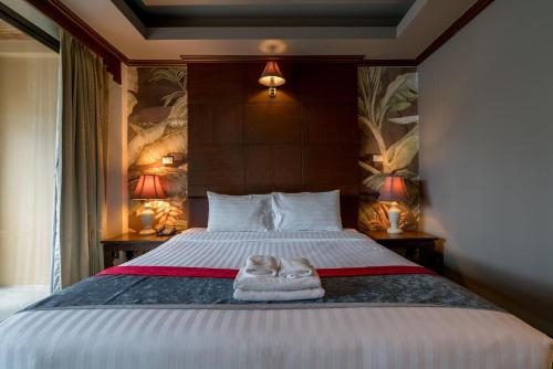Postel nebo postele na pokoji v ubytování Grand Orlov Apart Hotel