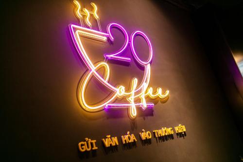 a neon sign that says off with a sign that reads gift way too at Hai Mươi Hotel & Apartment in Hanoi