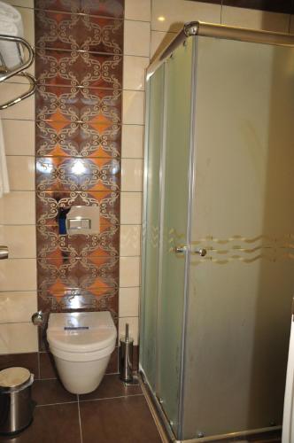 a bathroom with a toilet and a shower at Aura Boutique Hotel in Side