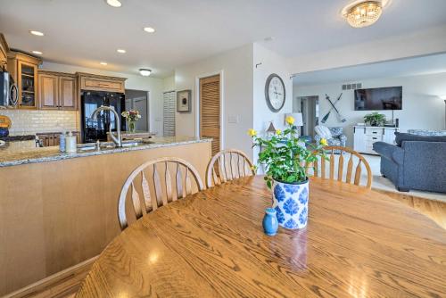 a dining room table with a vase of flowers on it at Waterfront East China Home with Dock and Patio! in Marine City