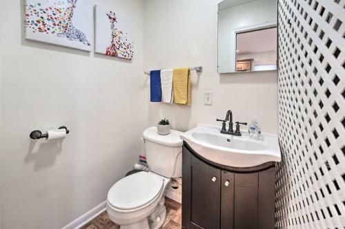 a bathroom with a toilet and a sink at Waterfront East China Home with Dock and Patio! in Marine City