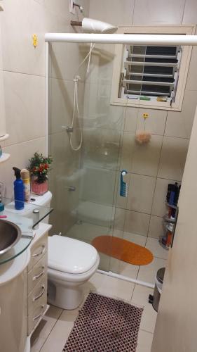 a bathroom with a shower with a toilet and a sink at Graça de Casa in Florianópolis