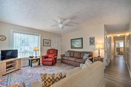 a living room with a couch and a tv at Cozy Oak Island House Less Than 1 Mi to Beaches! in Oak Island