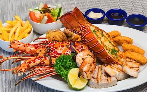 a plate of food with seafood and french fries at Blue Diamond Resort in Trincomalee