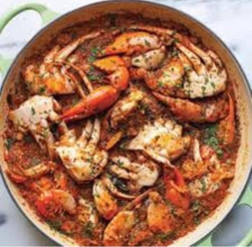a pan of food with shrimp and vegetables in it at Blue Diamond Resort in Trincomalee