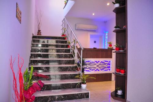 a staircase in a room with potted plants at Aura Boutique Hotel in Side