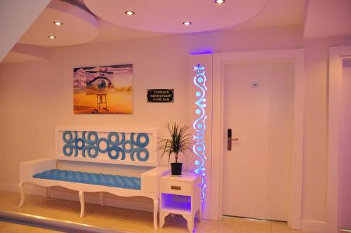 a room with a bench with a blue light at Aura Boutique Hotel in Side