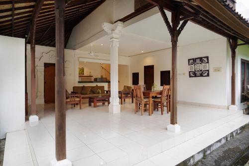 a dining room and living room of a house at Kusuma Resort Seminyak in Seminyak