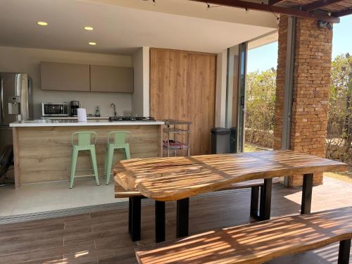 an outdoor kitchen with wooden tables and a counter at Ocean Club Resort Beach House in Juan de Acosta