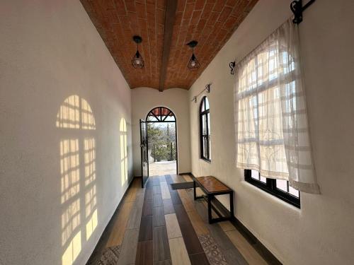 an empty hallway with windows and a wooden ceiling at Casa Malva Sweet Stay in Guanajuato