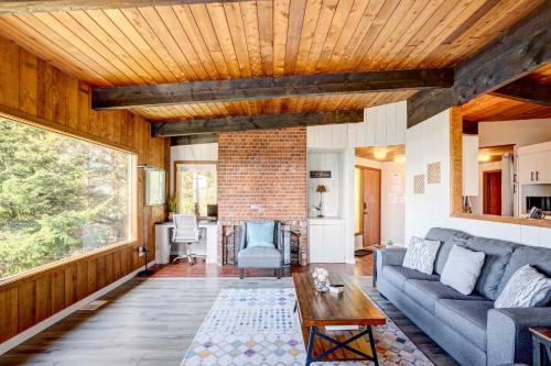 a living room with a couch and a table at Ocean Vista Gold Beach Getaway! in Gold Beach