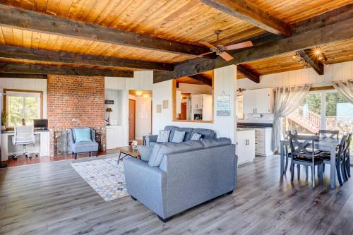 a living room with a couch and a table at Ocean Vista Gold Beach Getaway! in Gold Beach