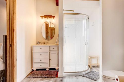 a bathroom with a shower and a sink and a mirror at Ocean Vista Gold Beach Getaway! in Gold Beach