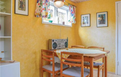 a dining room with a table with chairs and a television at Awesome Home In Onsala With 1 Bedrooms And Wifi in Onsala