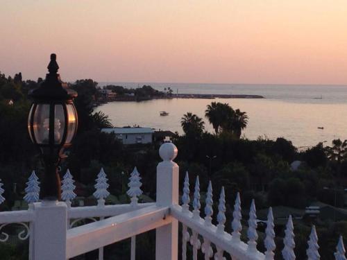 a view of the ocean from a white fence with a street light at Aura Boutique Hotel in Side