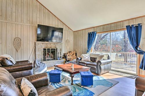 a living room with leather furniture and a fireplace at Game Room, Fire Pit Family-Friendly Poconos Haven in East Stroudsburg