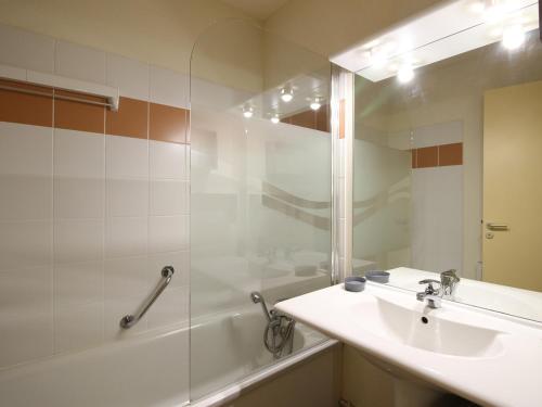 a bathroom with a sink and a shower and a tub at Appartement La Bourboule, 2 pièces, 5 personnes - FR-1-608-243 in La Bourboule