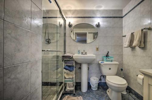 a bathroom with a shower and a toilet and a sink at Bethesda Apartment and Yard about 9 Mi to D C in Bethesda