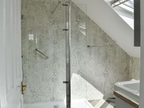 a glass shower in a bathroom with a sink at The Fairway in Westgate-on-Sea