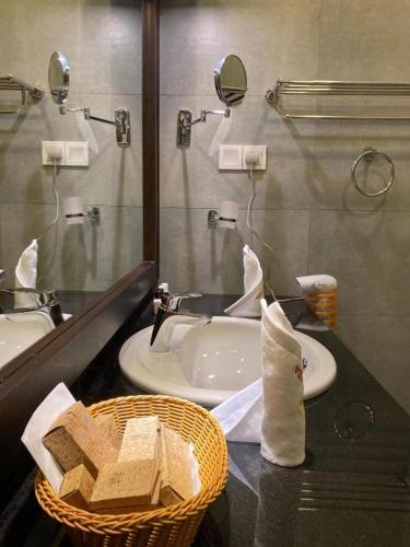 a bathroom with a sink and a mirror at Serenity Villa Dambulla in Sigiriya