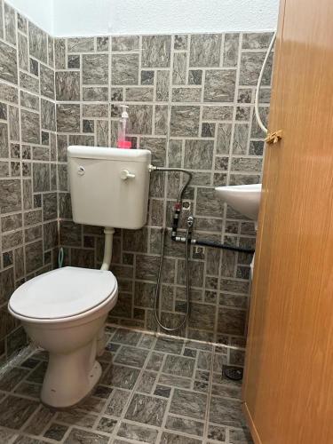 a bathroom with a toilet and a sink at G99 Hotel in George Town