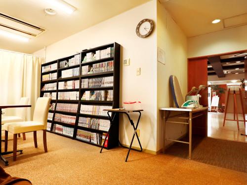 a room with a book shelf filled with books at Hotel Abest Shin-Anjo-Ekimae in Anjo