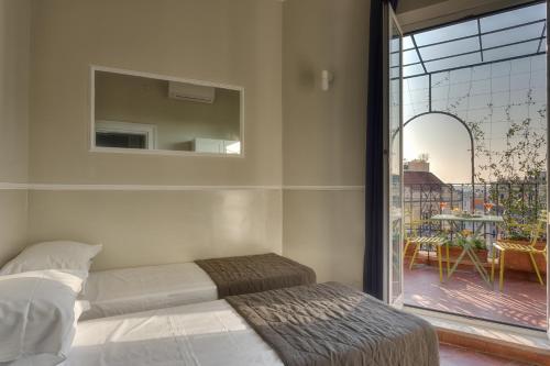 a bedroom with a bed and a view of a patio at Tritone Top House in Rome