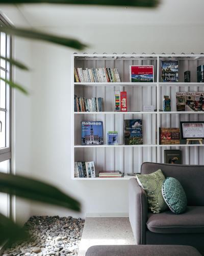 a living room with a book shelf filled with books at JM Boutique Hotel in Phu Quoc