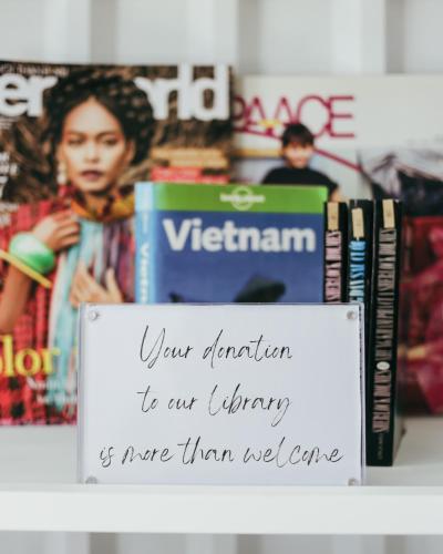 a sign sitting on top of a shelf with books at JM Boutique Hotel in Phu Quoc