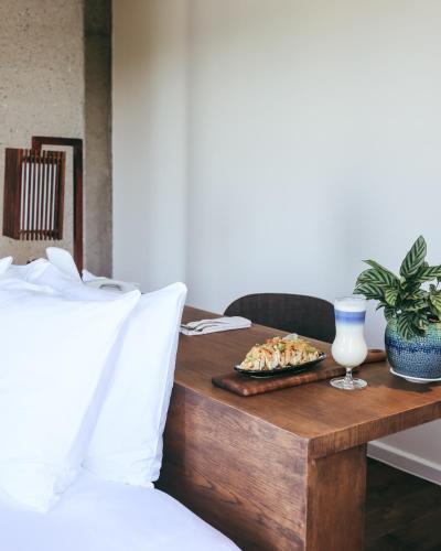 a table with a plate of food on top of a bed at JM Boutique Hotel in Phu Quoc