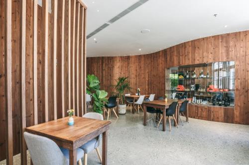 a restaurant with wooden walls and tables and chairs at JM Boutique Hotel in Phu Quoc