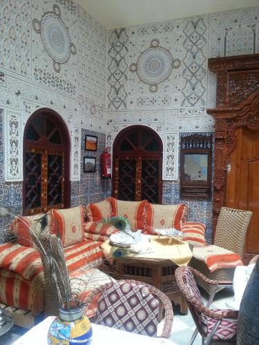 a living room with a couch and a table at Ryad Bab Berdaine in Meknès