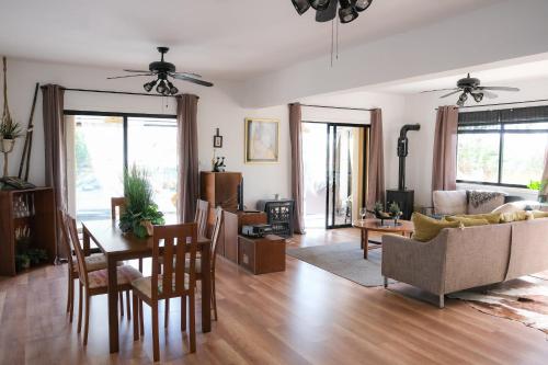 a living room with a table and a couch at Jonty Villa, Mazotos in Larnaka