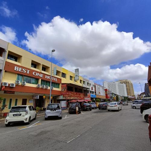 a city street with cars parked on the street at Best One Hotel in Malacca