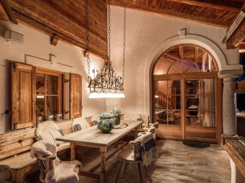 a dining room with a wooden table and chairs at Exclusive Tyrolean Chalet near Ski lifts in Apfeldorf