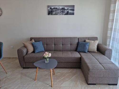 a living room with a couch and a table at Ma Maison Bleue in Kremasti