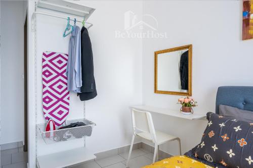 a bedroom with a desk and a chair and a mirror at Astetica Residences Kuala Lumpur in Seri Kembangan