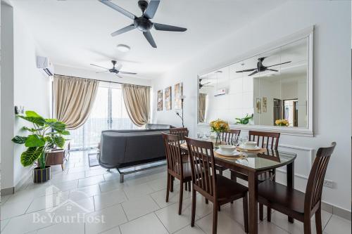 a dining room with a table and chairs and a couch at Astetica Residences Kuala Lumpur in Seri Kembangan
