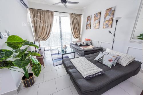 a living room with a couch and a table at Astetica Residences Kuala Lumpur in Seri Kembangan