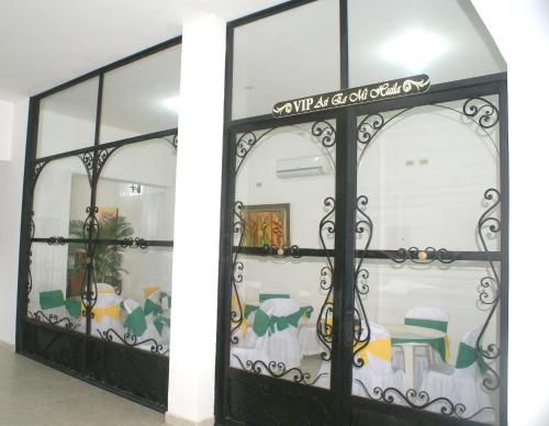 a glass door with a wrought iron gate at Hotel Casa Pablo in Neiva