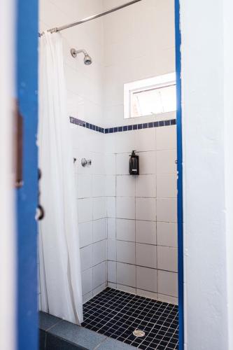 a bathroom with a shower with a black and white tiles at Villa Viva Cape Town in Cape Town