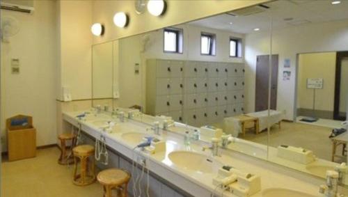 a large bathroom with sinks and a large mirror at Isawa no Sato in Shiso