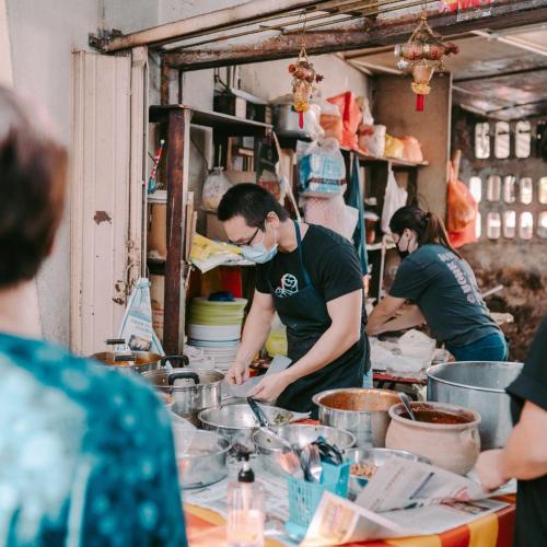 a group of people in a kitchen preparing food at The Chow Kit - an Ormond Hotel in Kuala Lumpur