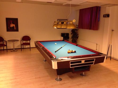 a pool table in a living room with a pool ball at Hotel Kemijärvi in Kemijärvi